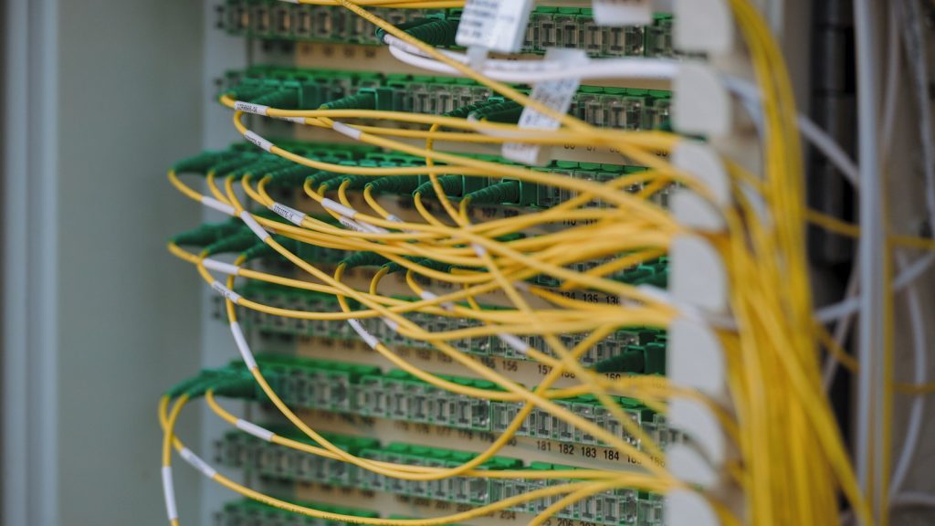 Fibre-optic cables and networking connections in a data center.