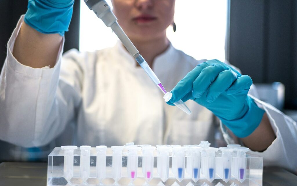 Scientist using a pipette in a laboratory, illustrative stock photograph