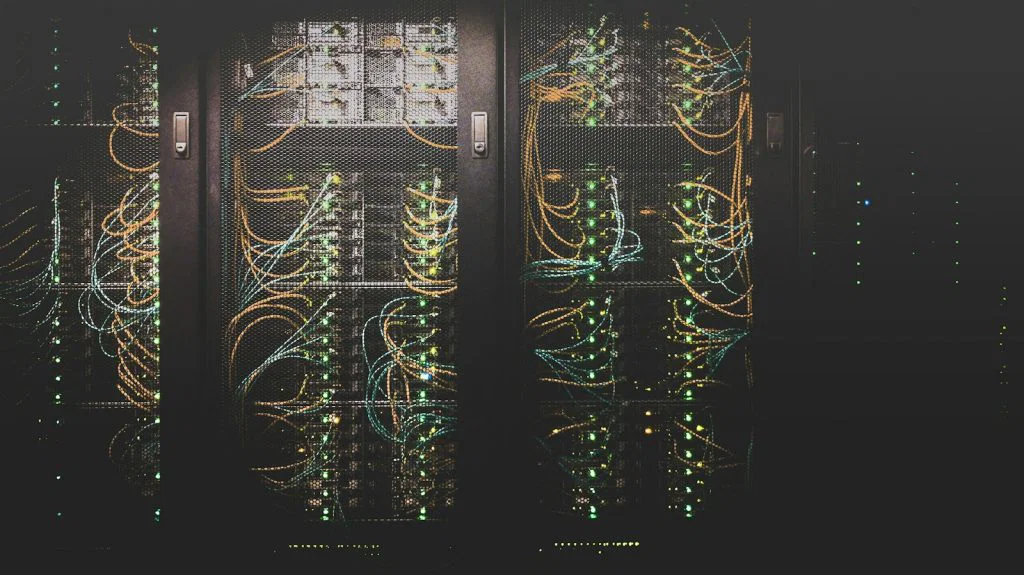 Server racks and network cabling, used as a representative cloud infrastructure photograph.