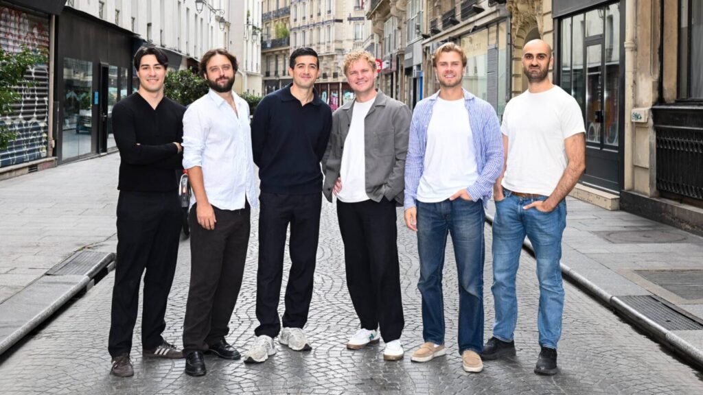 Six people posing together on a city street in the Vessla funding announcement photograph