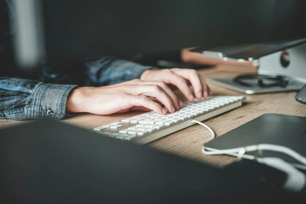 Person working at a computer, an illustrative photograph for comparing n8n agent and workflow design.